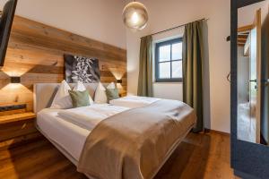 a bedroom with a large white bed in a room at Chalet Edelweiss in Niedernsill