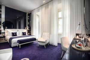 a bedroom with a bed and a table and chairs at Portugal Boutique Hotel in Lisbon