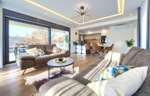 a living room with two couches and a table at Villa Andante in Krk