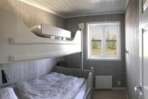 a bedroom with a bunk bed and a window at Modern cottage at Nordseter/Sjusjøen/Lillehammer in Lillehammer