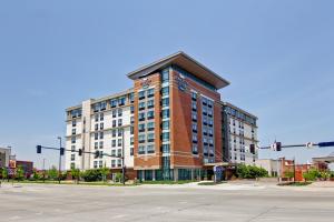 a large brick building on the corner of a street at Homewood Suites by Hilton Omaha - Downtown in Omaha