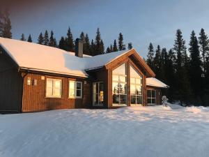 a house with snow on the ground in front at Modern cottage at Nordseter/Sjusjøen/Lillehammer in Lillehammer