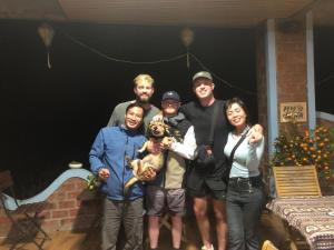 a group of people standing in front of a christmas tree at An An Homestay Bungalow in Phong Nha