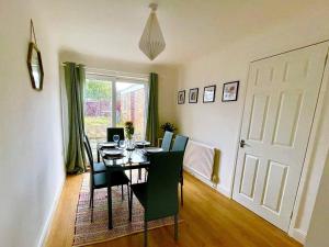 a dining room with a table and chairs and a door at Comfortable Contractor Let 4bed in Lincolnshire