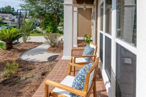 two chairs sitting on the porch of a house at Burnside Beauty 4BR Pingpong Patio in Tallahassee