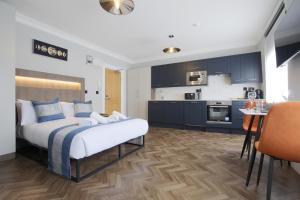 a bedroom with a bed and a kitchen at Imperial York Street Apartments in London