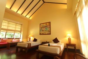 A bed or beds in a room at The Hotel @ Tharabar Gate