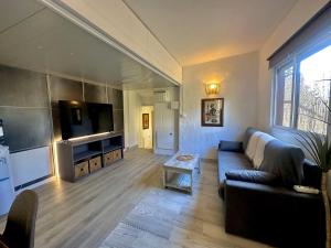 een woonkamer met een bank en een flatscreen-tv bij La Villa Verde in Tarifa
