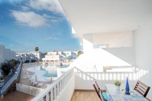 a balcony with a view of a swimming pool at The 9 souls - pool view in Costa Teguise