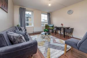 a living room with a couch and a table at The Mount in London