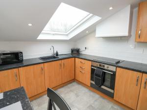 a kitchen with a sink and a stove at Springwell Lodge in Exeter