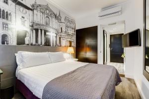 - une chambre avec un grand lit et une fresque murale dans l'établissement Residenza A -Via Veneto Fashion Rooms -self check-in, à Rome