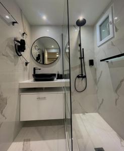 a bathroom with a shower and a mirror at Monastiraki Heart - Luxury Apartment Athens in Athens