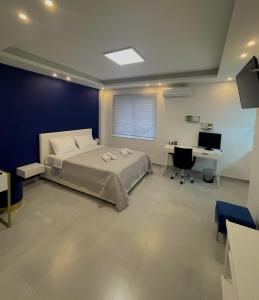 a bedroom with a bed and a desk and a computer at Monastiraki Heart - Luxury Apartment Athens in Athens