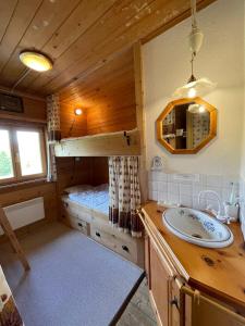 a bathroom with a sink and a bunk bed at Zauberberg in voller Pracht in Sertig Döfli