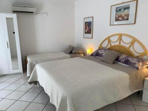 um quarto com duas camas num quarto em Casetta nel Giardino -Ischia em Ischia