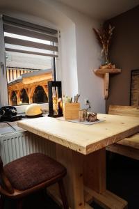 a kitchen with a wooden counter top with a window at Pension Haus Fürstenberg in Grünhain-Beierfeld