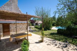 a swing in the yard of a house at Longère classée 4 étoiles - piscine – Ambillou in Ambillou