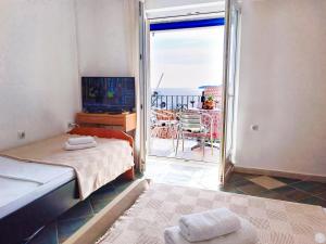 a bedroom with a bed and a view of the ocean at Amisos Boutique Hotel in Bečići