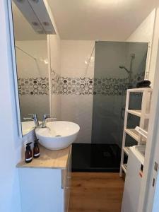 a bathroom with a white sink and a shower at .L'Armor. Appartement avec terrasse & parking in Les Sables-d'Olonne