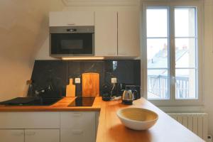 a kitchen with a counter top with a bowl on a counter at Let's take a walk in the woods in Tours