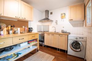 a kitchen with a sink and a washing machine at In the heart of silence - Nice house in Tours