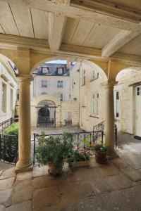 a view of a building with columns and plants at Exceptional location L'Hôtel des Gouverneurs in Chinon