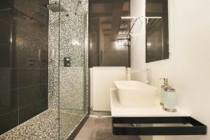 a bathroom with a sink and a shower at Exceptional location L'Hôtel des Gouverneurs in Chinon