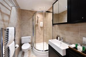 a bathroom with a shower and a toilet and a sink at The Townhouse Ayr - Luxury B&B - adults only in Ayr +100 photos