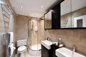 a bathroom with a toilet and a shower and a sink at The Townhouse Ayr - Luxury B&B in Ayr