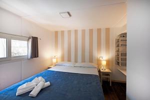 Postel nebo postele na pokoji v ubytování Camping Villaggio Nettuno
