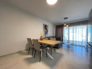 a dining room with a table and chairs at Urban Oasis in Ellinikon - Athenean BnB in Athens