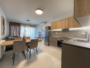 a kitchen with a table and a dining room at Urban Oasis in Ellinikon - Athenean BnB in Athens