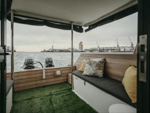 a seat on the back of a boat in the water at Waterfront Houseboat in Cape Town