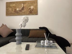 a living room with a couch and a table at Assalama Residency city center by TCE in Agadir