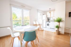 a kitchen and living room with a table and chairs at Pastel colors - Tours in Tours