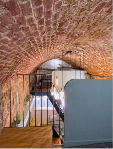 a staircase in a room with a brick wall at Appartement Atypique Au Pied Du Sacré Cœur in Paris