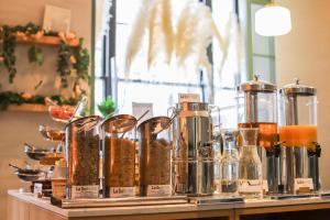 a counter with many jars of food on a shelf at La Suite West - Hyde Park in London