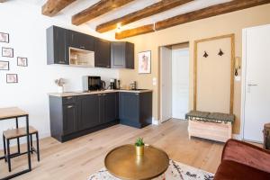 a kitchen with black cabinets and a table in a living room at Let's get some height in Tours