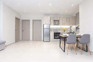 a kitchen with a table and a refrigerator at JΕΝΑ House in (( Agía Eleoúsa ))