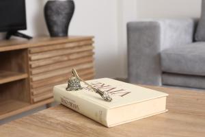 a book sitting on a table with a pair of tongs on it at JΕΝΑ House in (( Agía Eleoúsa ))