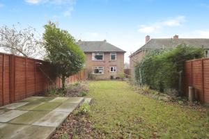 an empty backyard with a fence and a house at Beautiful home close to town Free Netflix, Wifi in Solihull