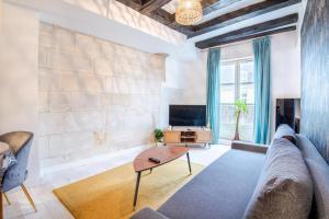 a living room with a couch and a table at At the heart of Vieux Tours festivities in Tours