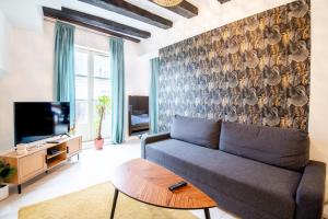 a living room with a couch and a tv at At the heart of Vieux Tours festivities in Tours