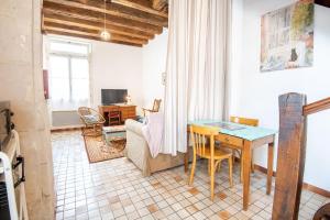 a living room with a table and a couch at L'authentique - Tours in Tours