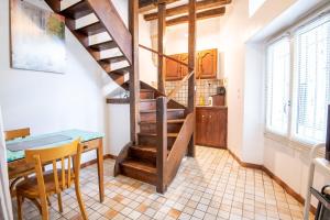 a kitchen with a staircase and a table and chairs at L'authentique - Tours in Tours