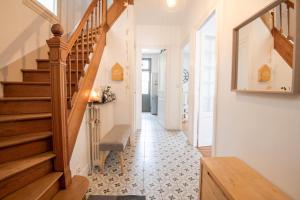 a hallway with a wooden staircase and a stair treadpelling at A corner of paradise in Tours