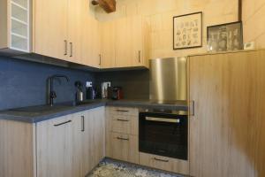 a kitchen with wooden cabinets and a sink and an oven at Lovely T2 in the heart of Tours in Tours
