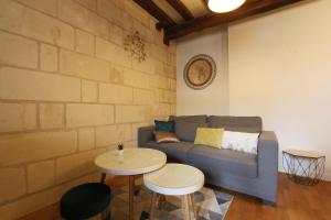 a living room with a couch and two tables at Lovely T2 in the heart of Tours in Tours