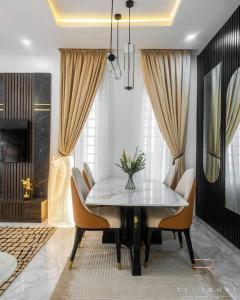 a dining room with a table and chairs at Stylish and Cozy 4 bedroom 4 bathroom Home Lekki in Lekki
